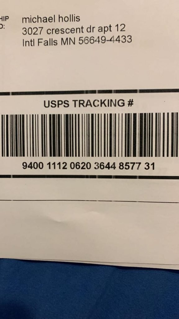 USPS shipping label on a delivered parcel showing tracking number 9400 1112 0620 3644 8577 31